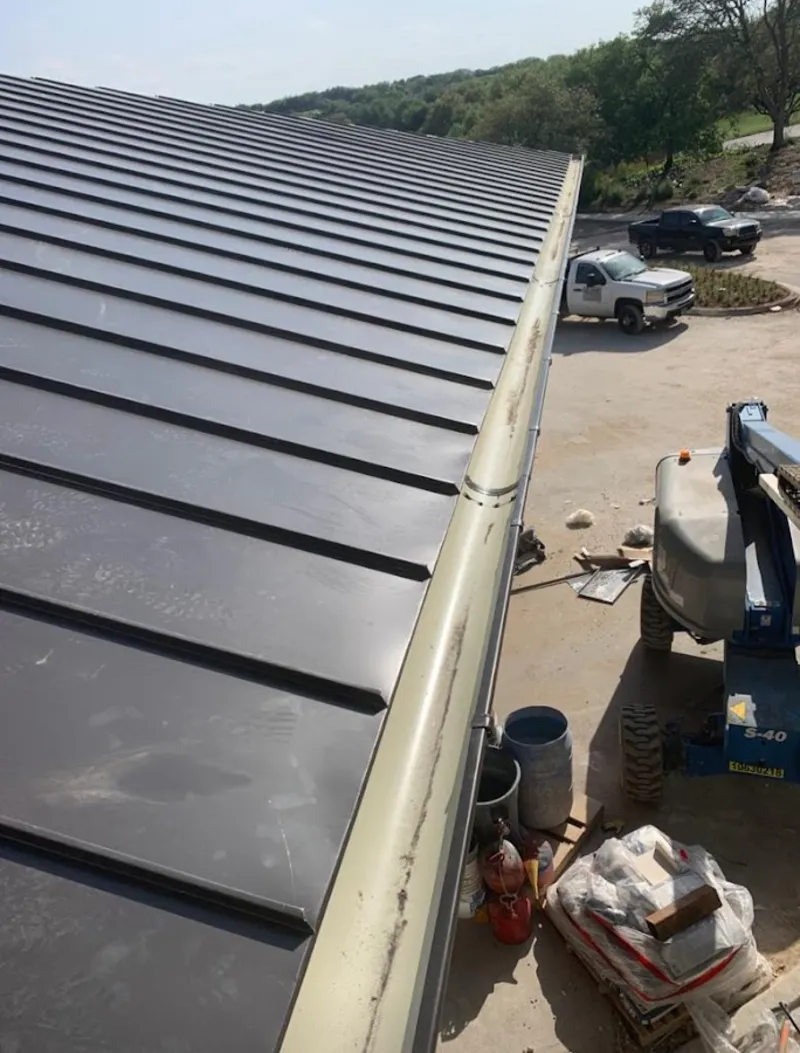 Standing seam panel and gutter detail on a metal roofing jobsite in Bennettsville